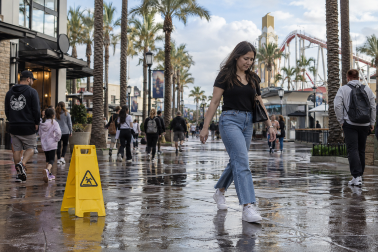 Pedestrians walking along busy Buena Park entertainment corridor
